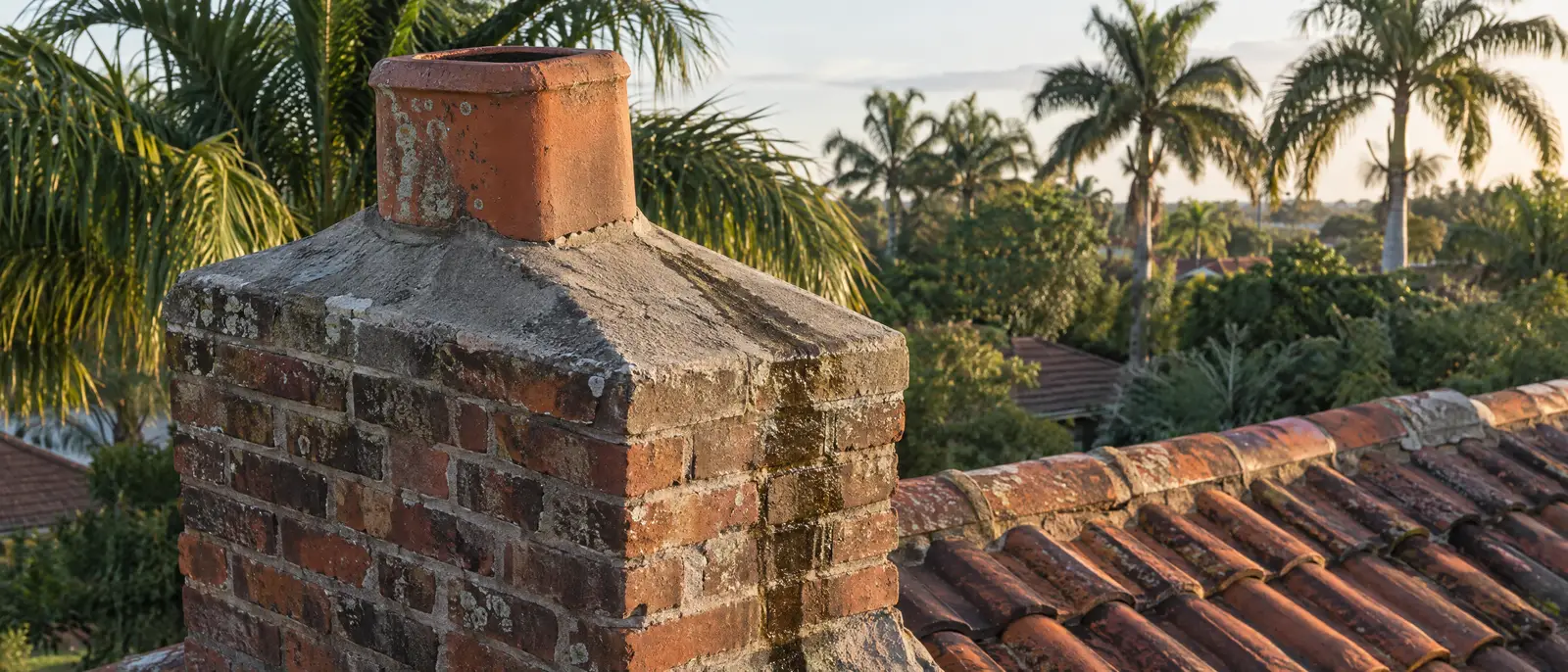 Sloped cap and flue tile on top of a masonry chimney